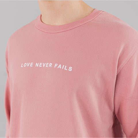 LOVE NEVER FAILS SWEATSHIRT ROSE